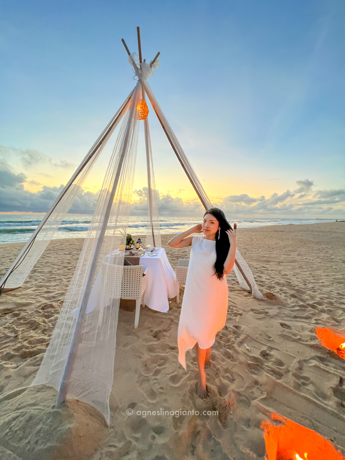 Woman having romantic candlelight dinner on the beach in Phuket