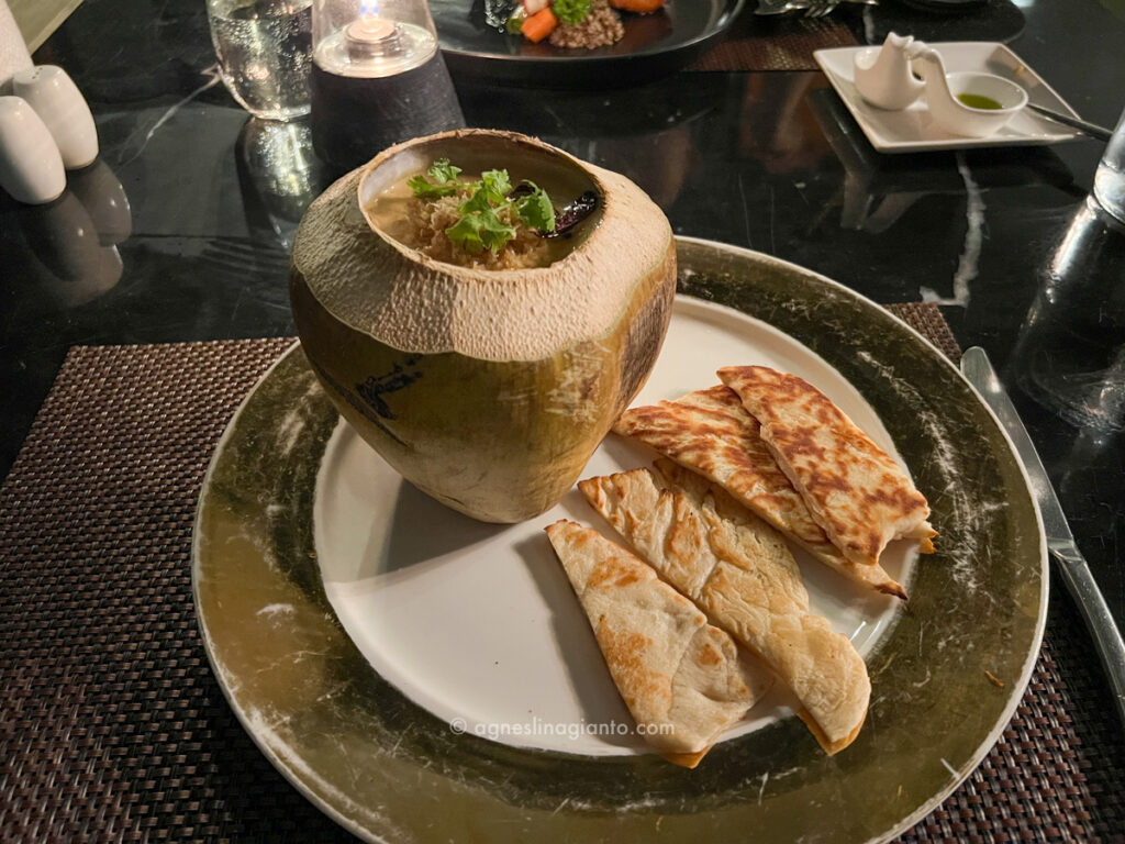 Curry served inside fresh coconut