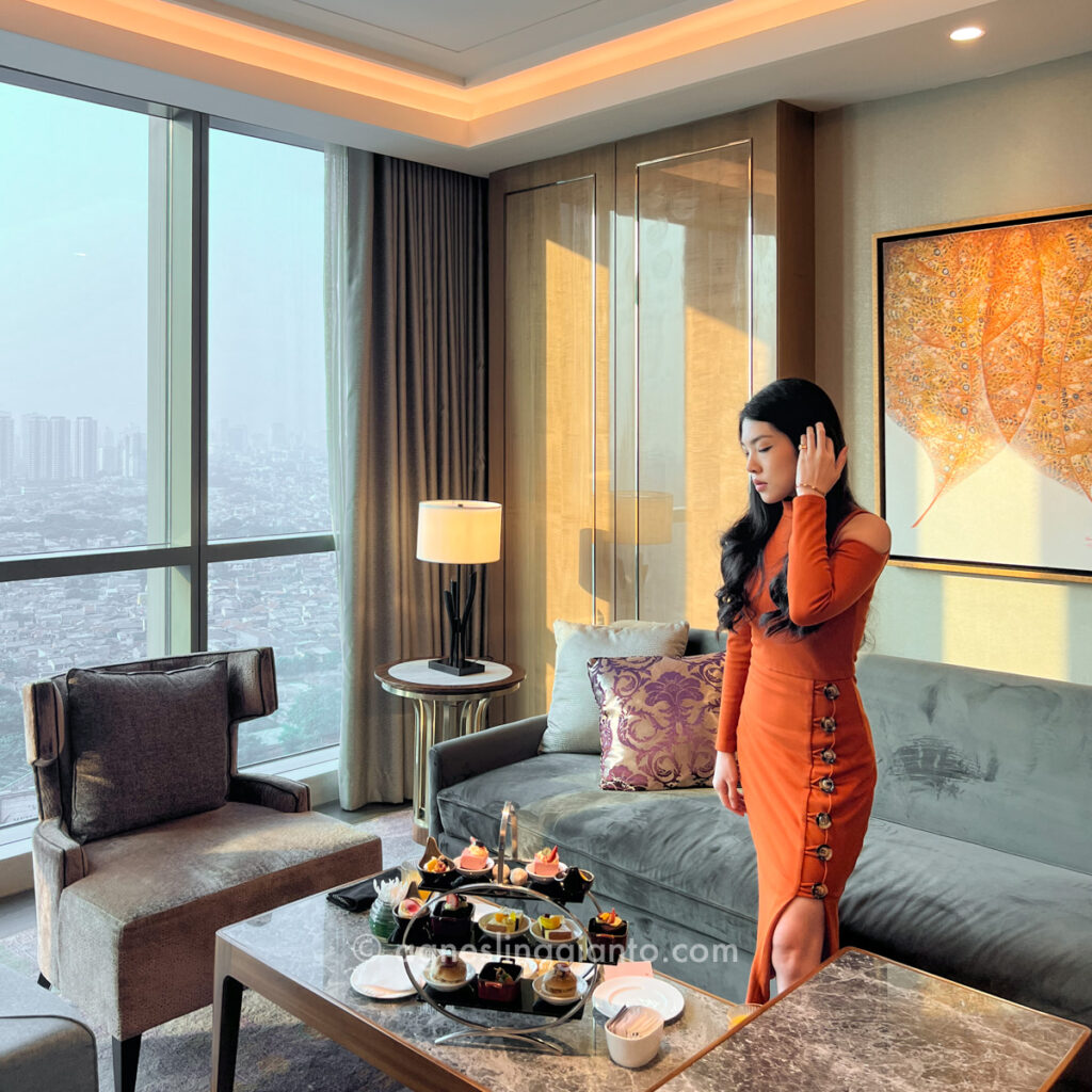 Asian female at 5 star luxury hotel club lounge enjoying afternoon tea set