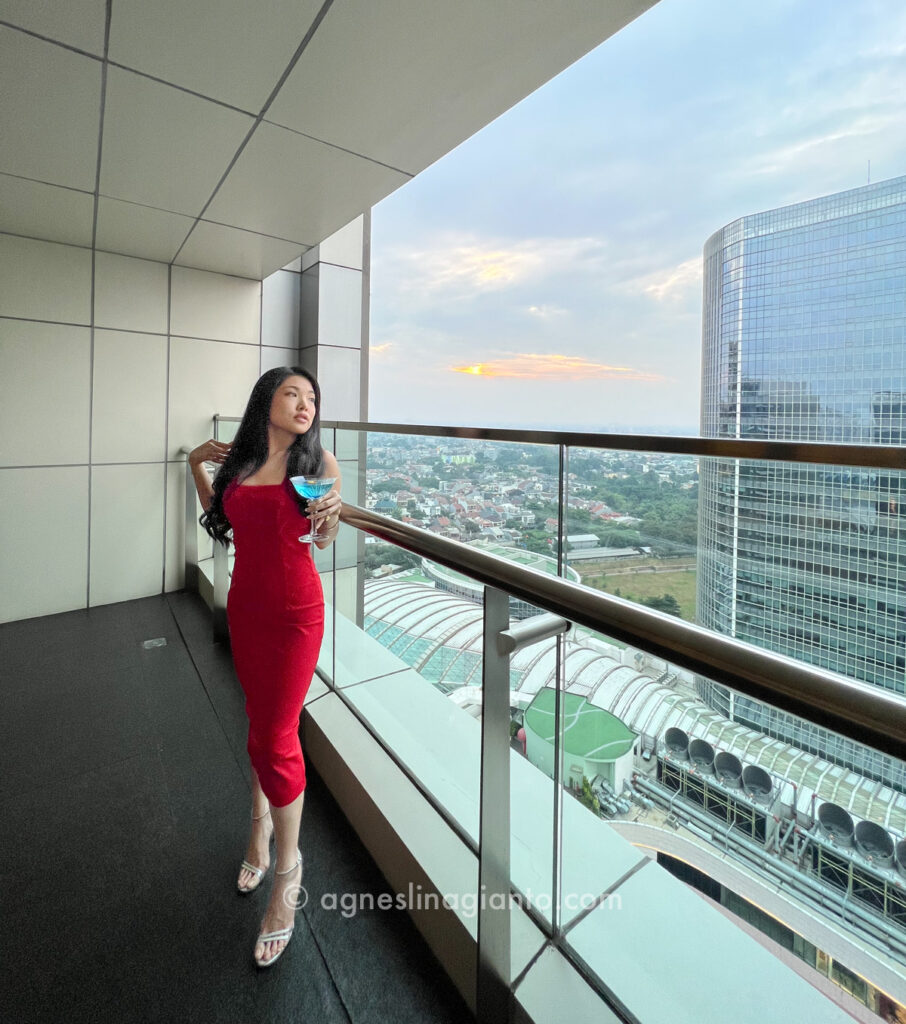 Beautiful asian woman drinking cocktail at a luxury hotel InterContinental Jakarta