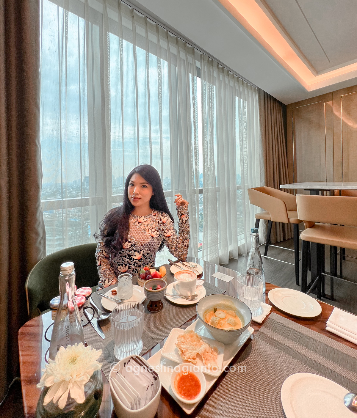Asian female having breakfast at luxury hotel