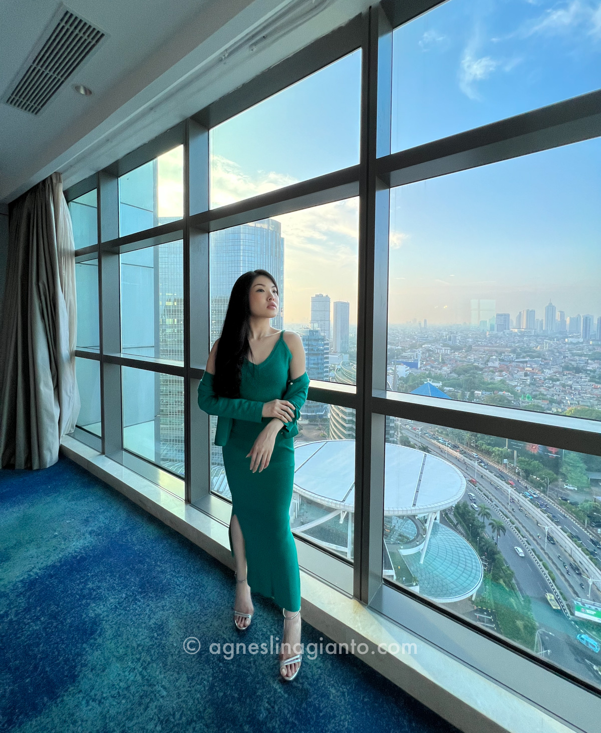 Attractive asian woman in 5 star luxury hotel with city view