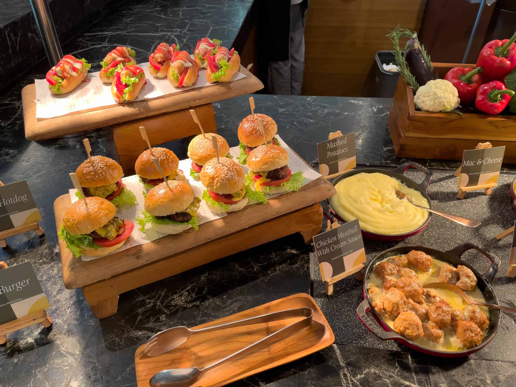 Mini gourmet sliders and savory canapés at a luxury hotel buffet.
