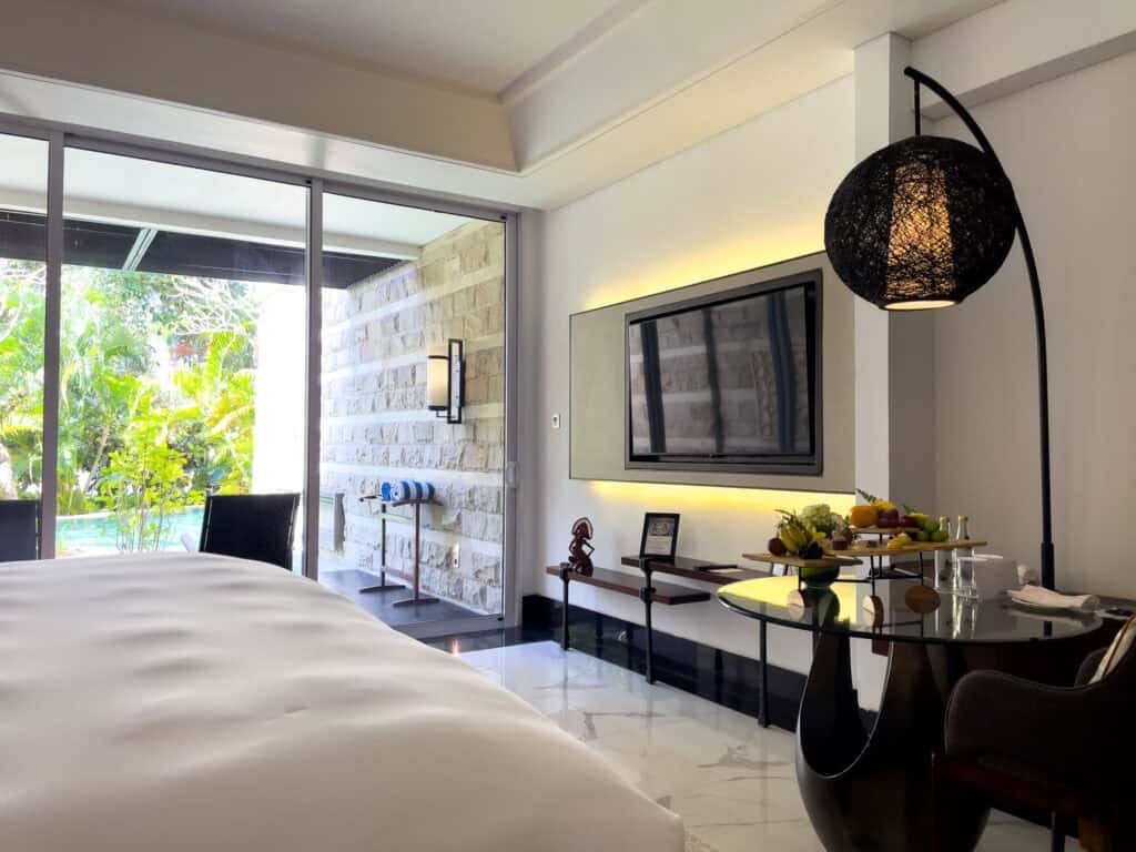 A Luxury Room with pool access at Sofitel Bali Nusa Dua, the bed facing glass doors onto the garden