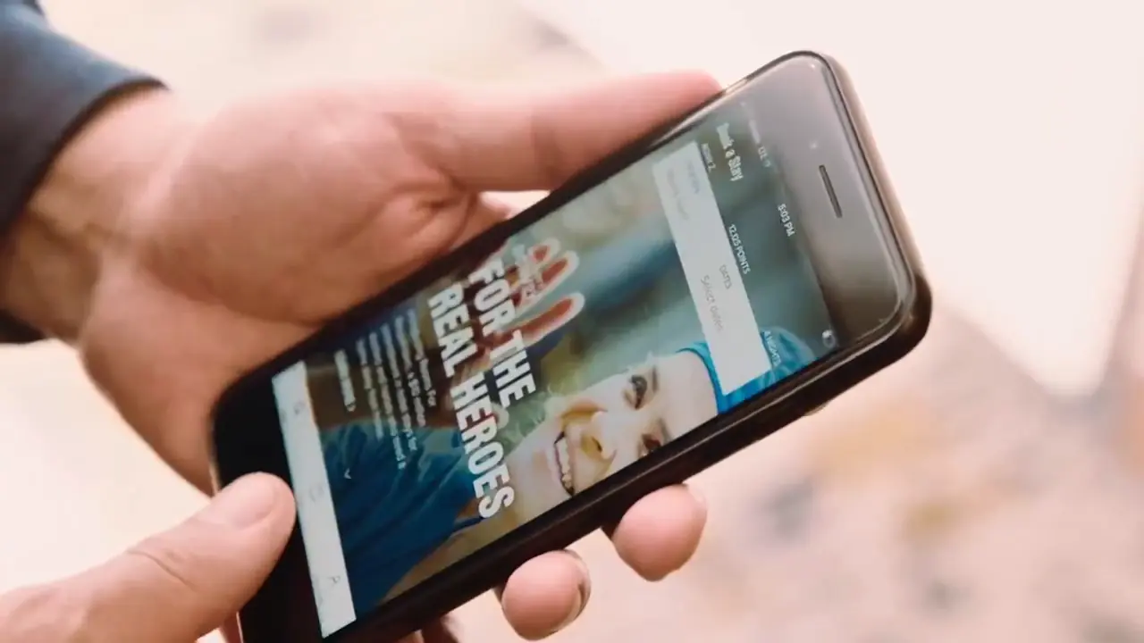 A hand holding a phone showing the Marriott Bonvoy app