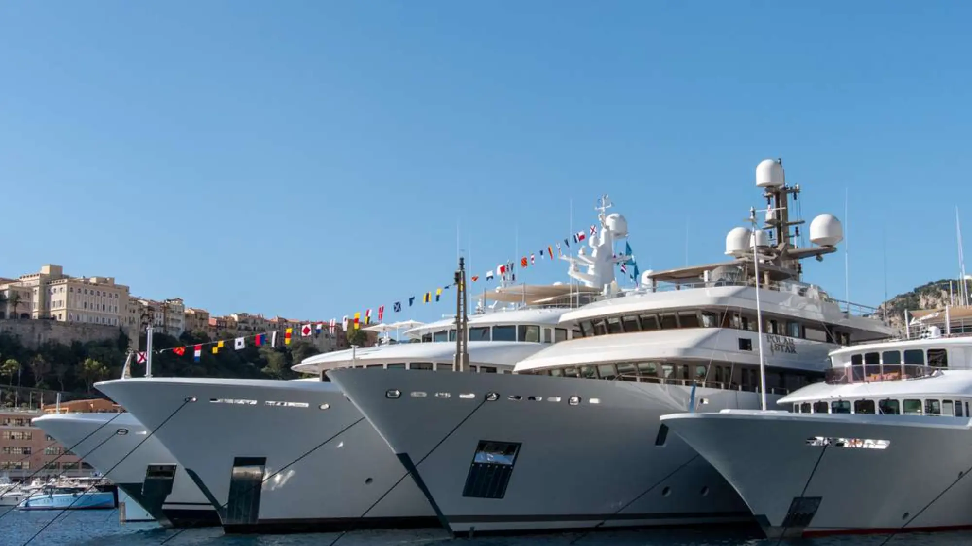 Superyachts moored along the harbour during the yacht show season
