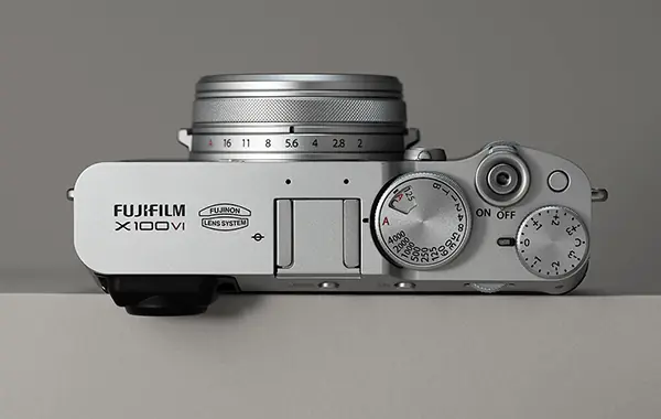 Top-down view of the silver Fujifilm X100VI showing its tactile control dials