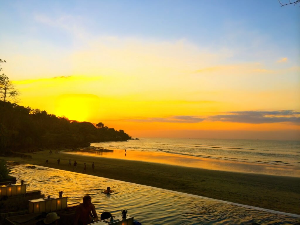Sunset over Jimbaran Bay, the beach and headland below Four Seasons Resort Bali at Jimbaran Bay
