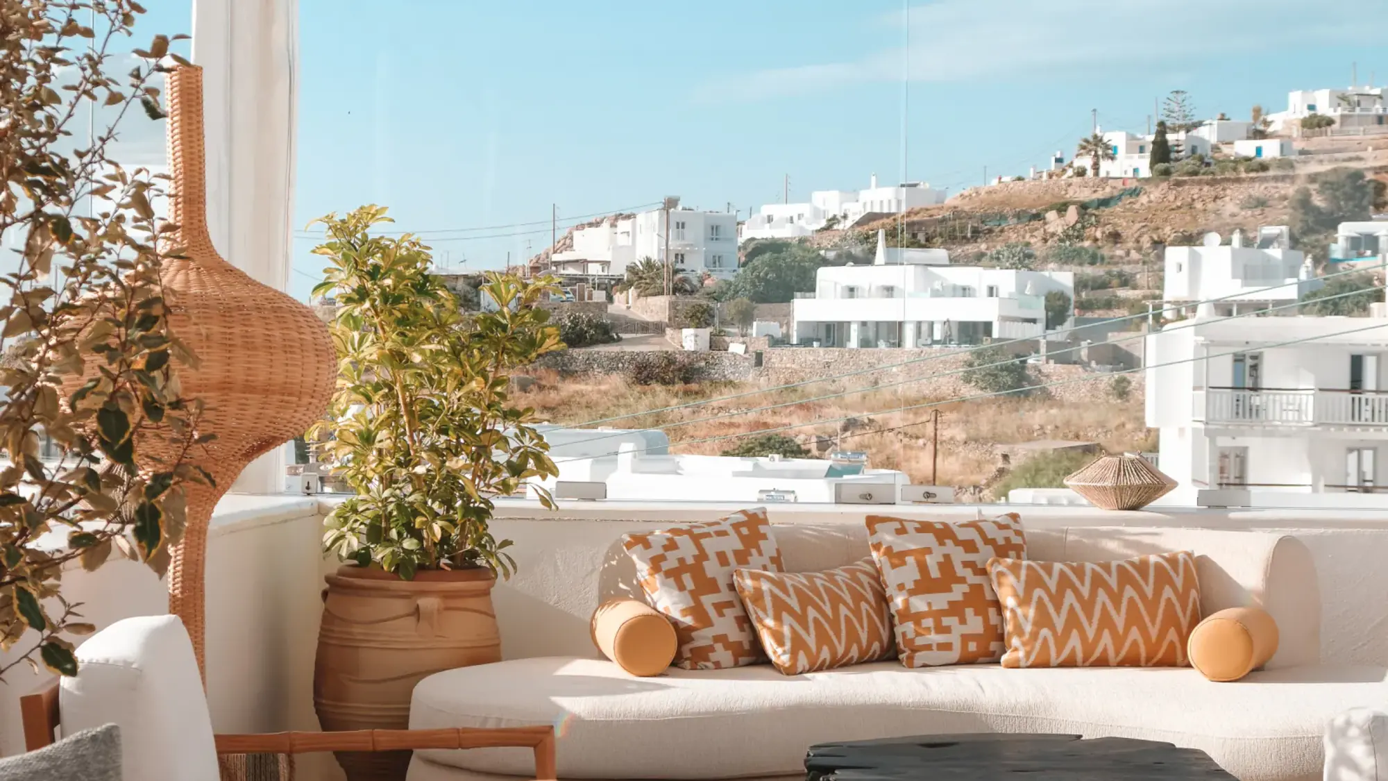 Terrace seating at Kove Mykonos overlooking the whitewashed hillside