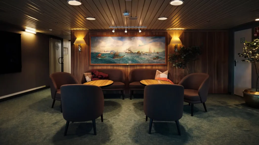 Lounge banquettes beneath a maritime painting aboard MS Vesteralen