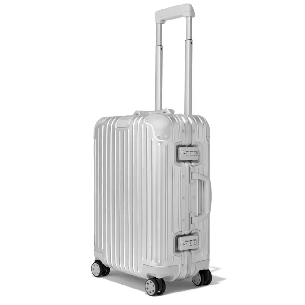 The silver Rimowa Original Cabin standing with its telescopic handle extended