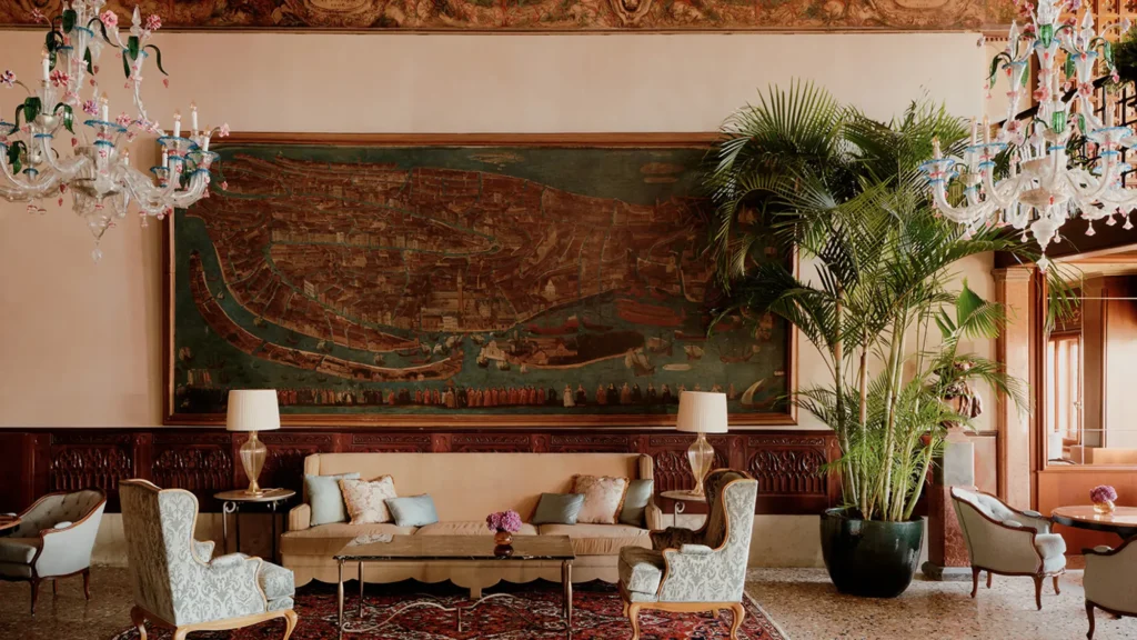 A lounge at Danieli, Venezia hung with Murano glass chandeliers beneath a large framed painting
