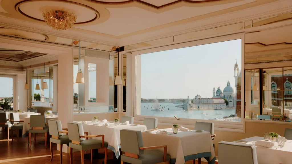 The restaurant interior at Danieli, Venezia framing a wide window onto the lagoon and Santa Maria della Salute