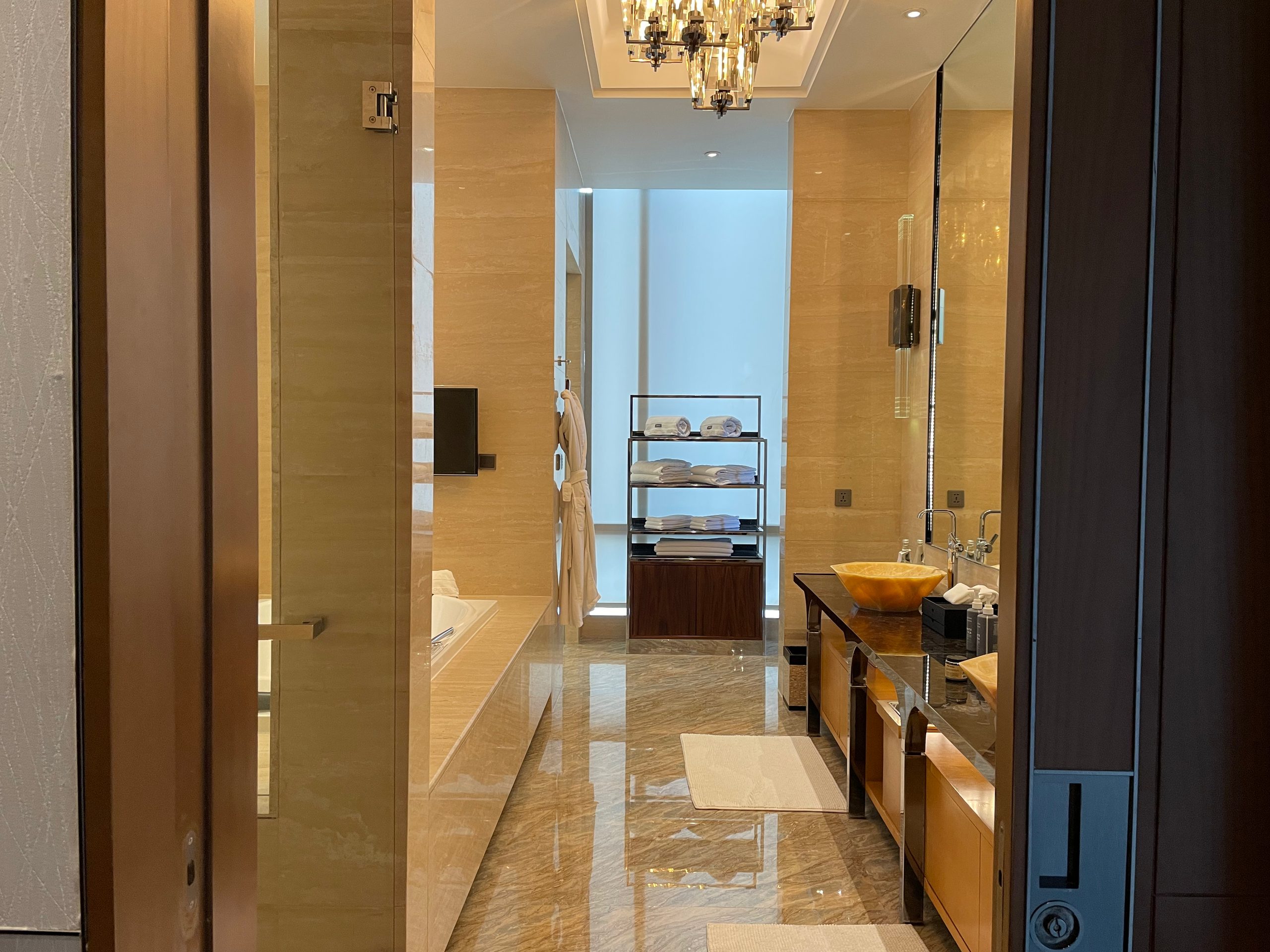 The main bathroom of the Ambassador Suite at The Westin Jakarta, with double onyx vessel sinks and a jacuzzi tub
