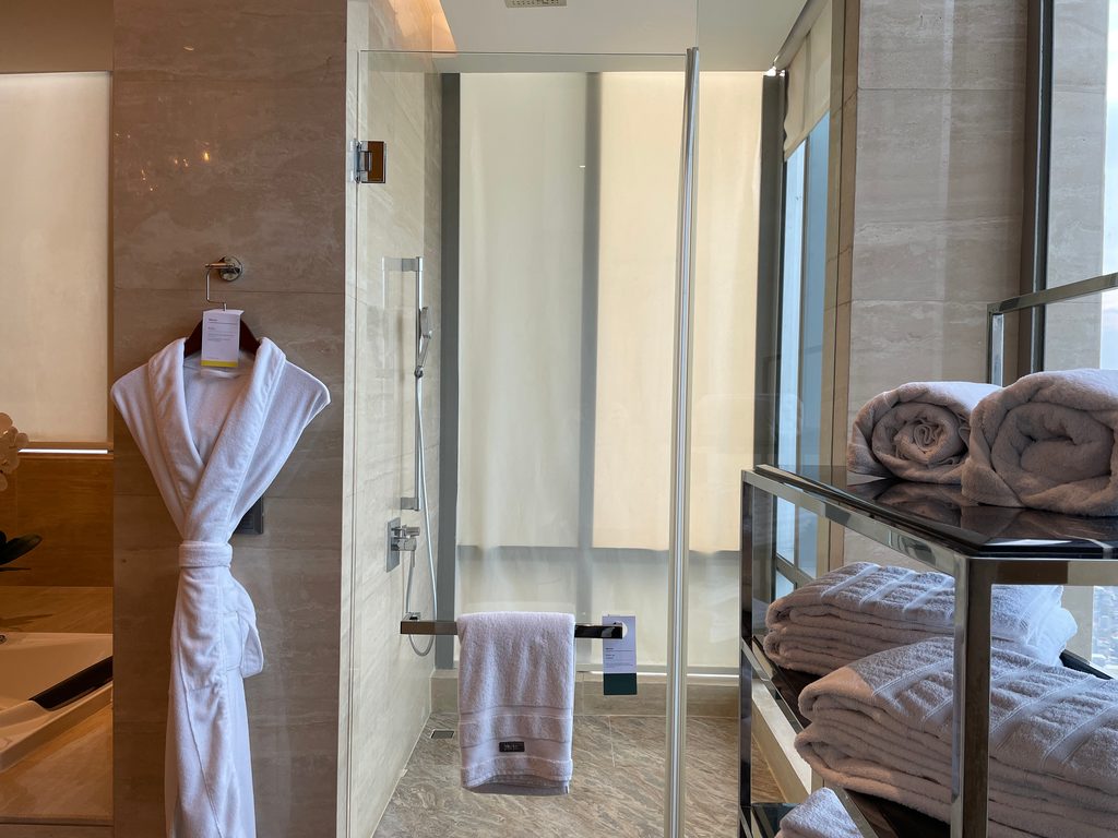 The main bathroom of the Ambassador Suite at The Westin Jakarta, with double onyx vessel sinks and a jacuzzi tub