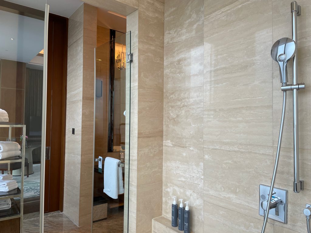 The main bathroom of the Ambassador Suite at The Westin Jakarta, with double onyx vessel sinks and a jacuzzi tub