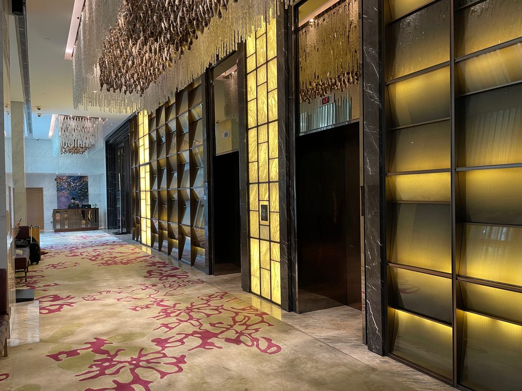 The ground-floor arrival corridor, leading to the express lifts — The Westin Jakarta