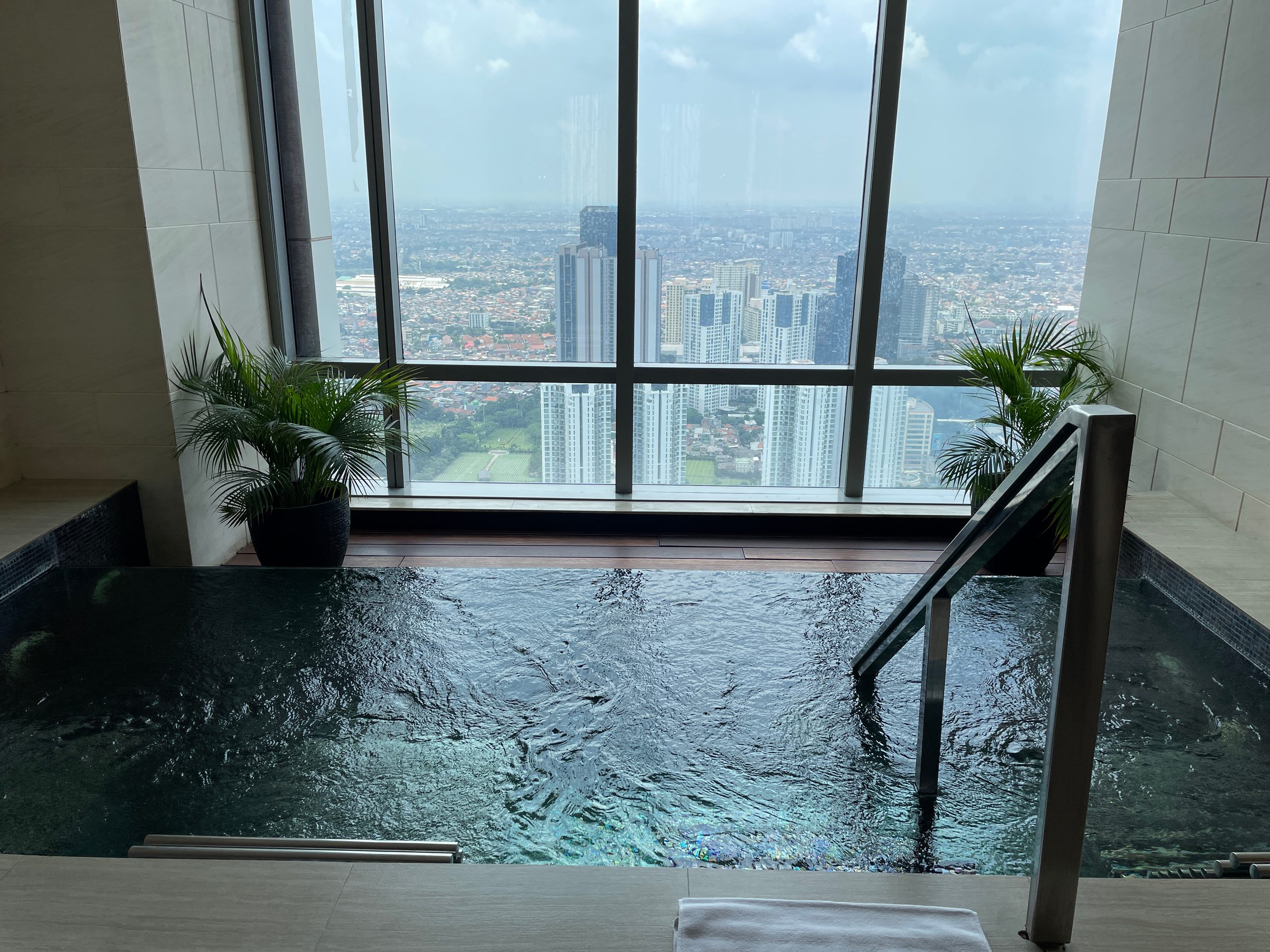 The hot bath, with the city below — The Westin Jakarta