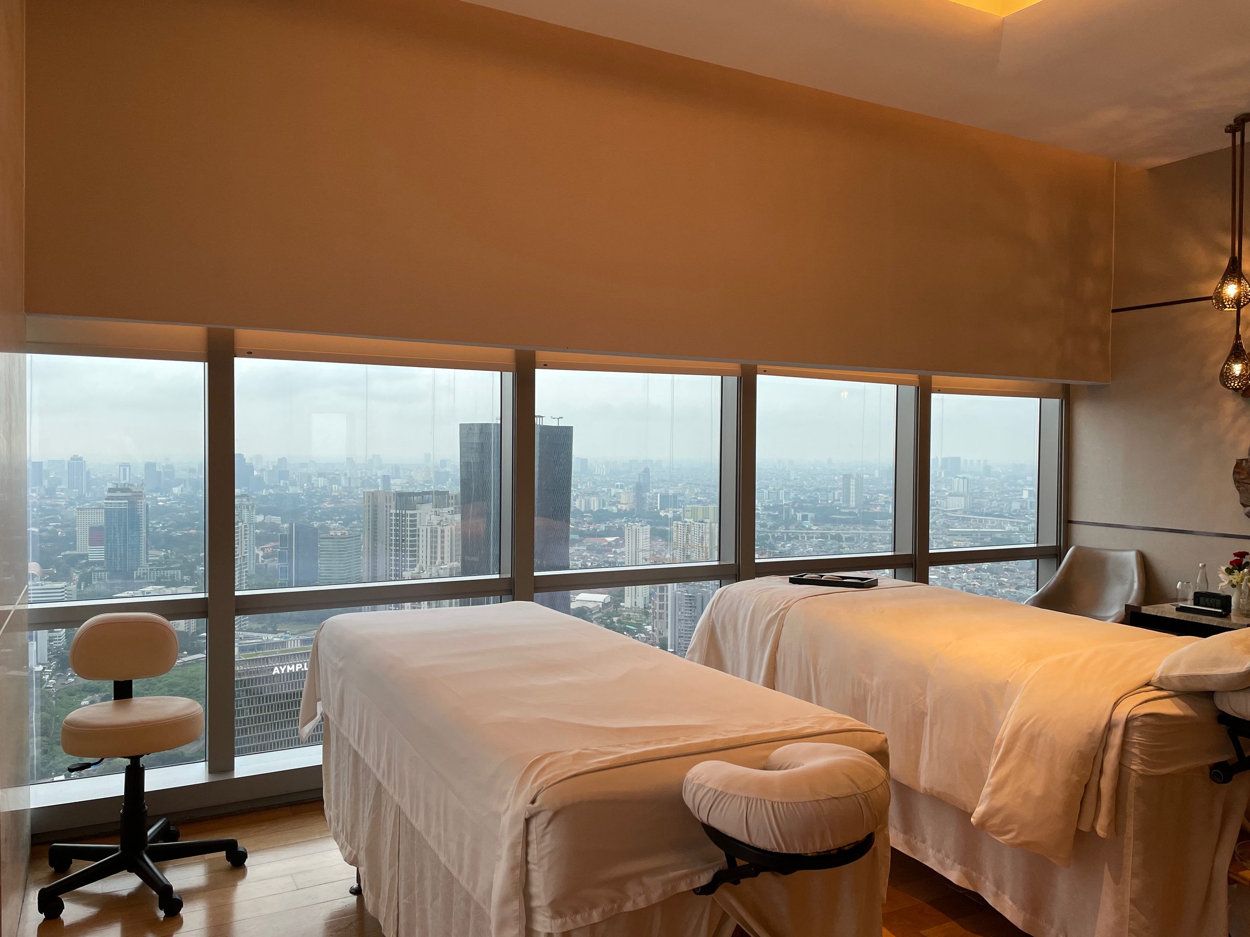 A couples treatment room, with two beds at the window — The Westin Jakarta