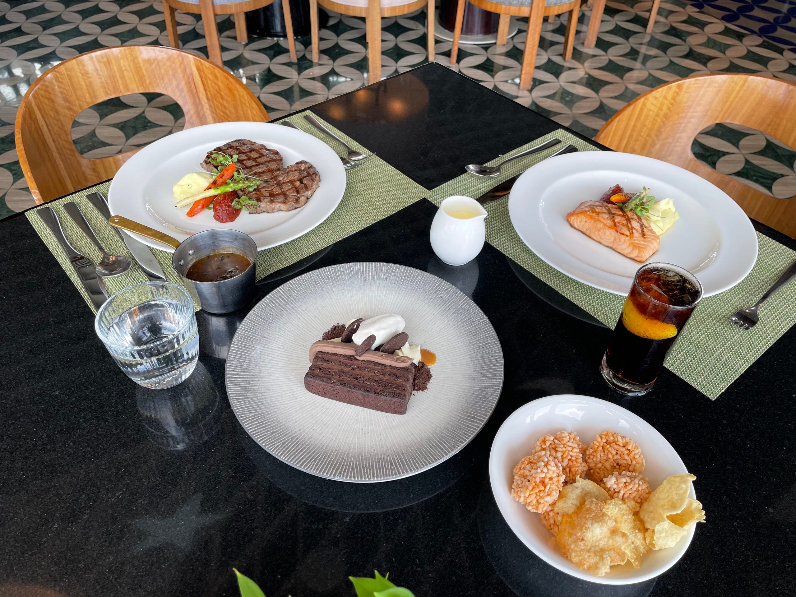 The a la carte lunch table: steak, salmon, chocolate cake and iced tea — The Westin Jakarta