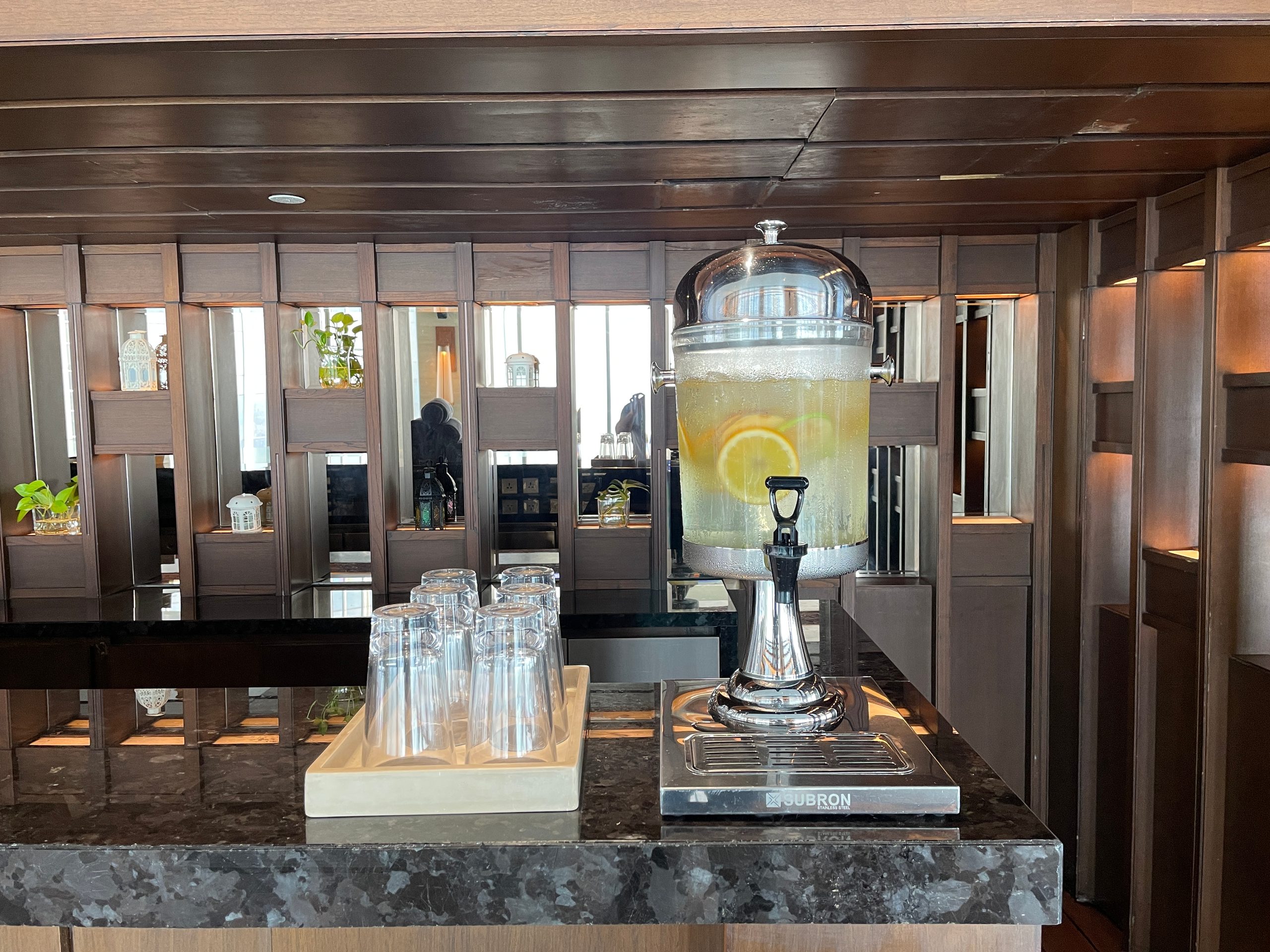 The poolside refreshment station on level 50 at The Westin Jakarta, with lemon-infused water and glasses