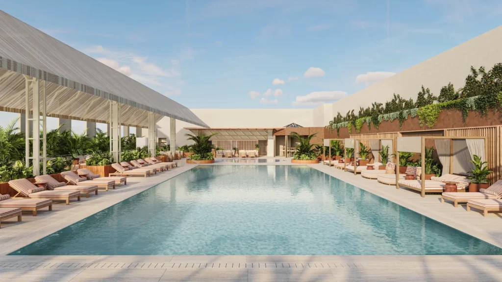 Pool deck at The Hari Singapore, lined with loungers and cabanas