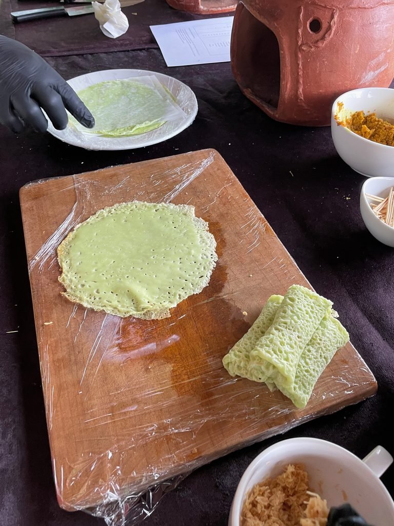 Green pandan crêpes on a board for dadar gulung at the cooking class, Visesa Ubud