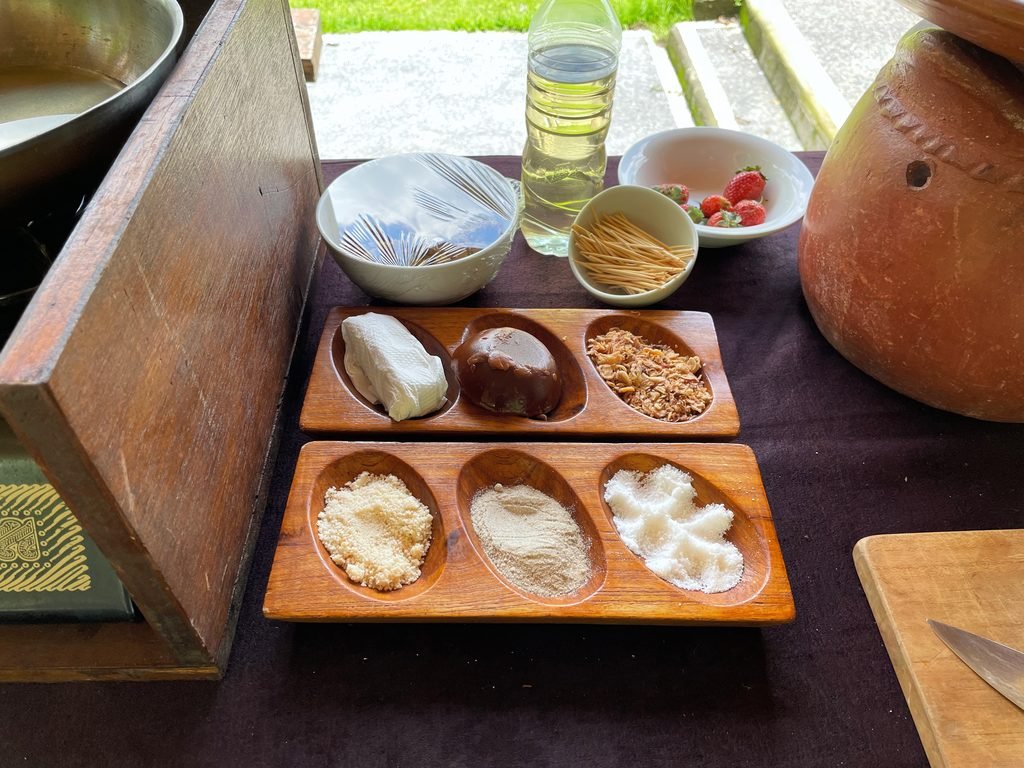 Palm sugar, grated coconut and seasonings portioned in wooden trays for the cooking class at Visesa Ubud
