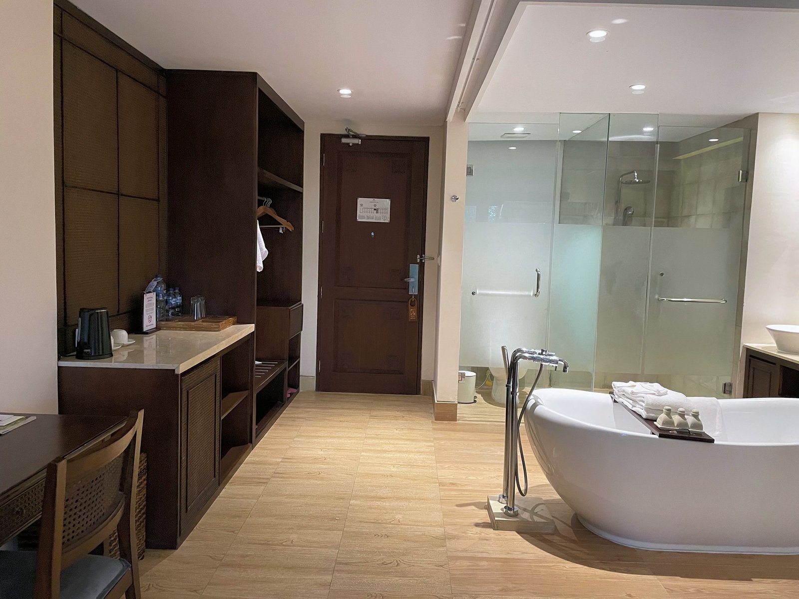 The bathroom end of the Jungle Suite at Visesa Ubud, with a freestanding tub, wardrobe and glass shower