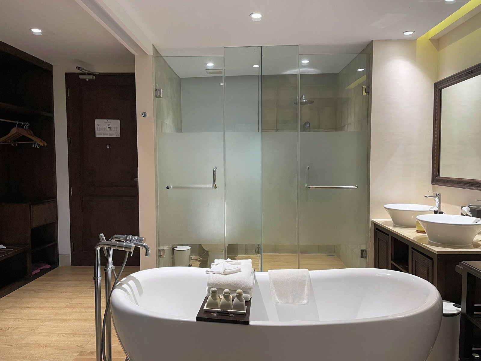 The freestanding bathtub with twin vessel basins behind in the Jungle Suite at Visesa Ubud