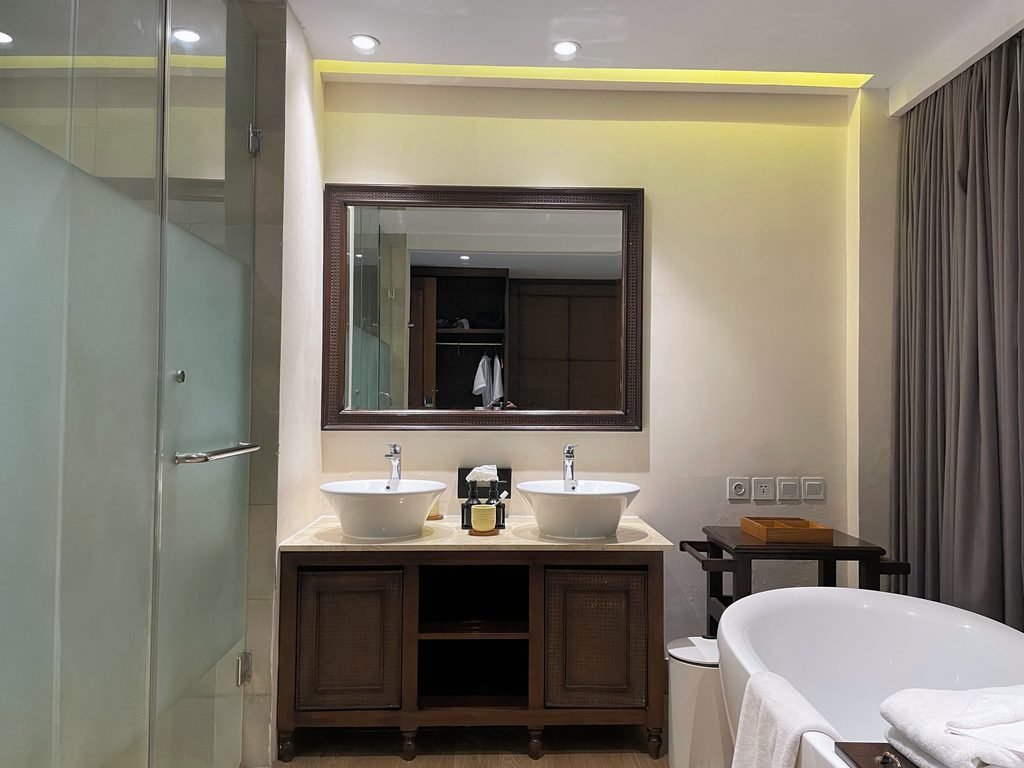Twin vessel basins on a dark timber vanity in the Jungle Suite at Visesa Ubud