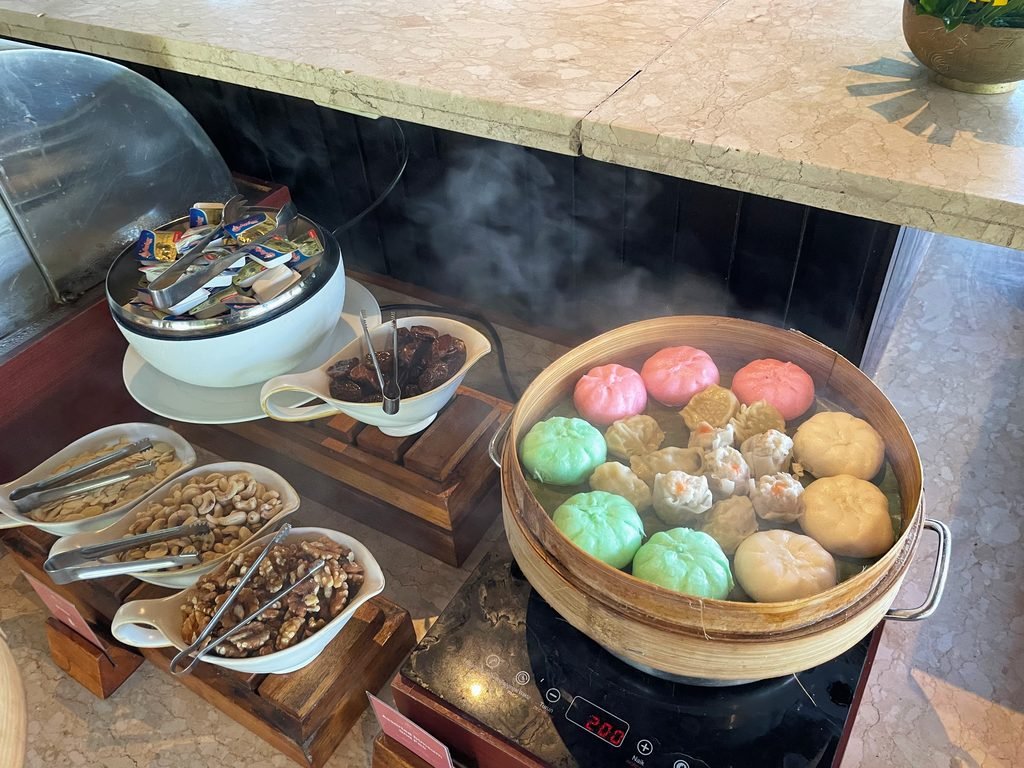 Coloured steamed buns and dim sum in a bamboo steamer at the Lesung breakfast buffet, Visesa Ubud