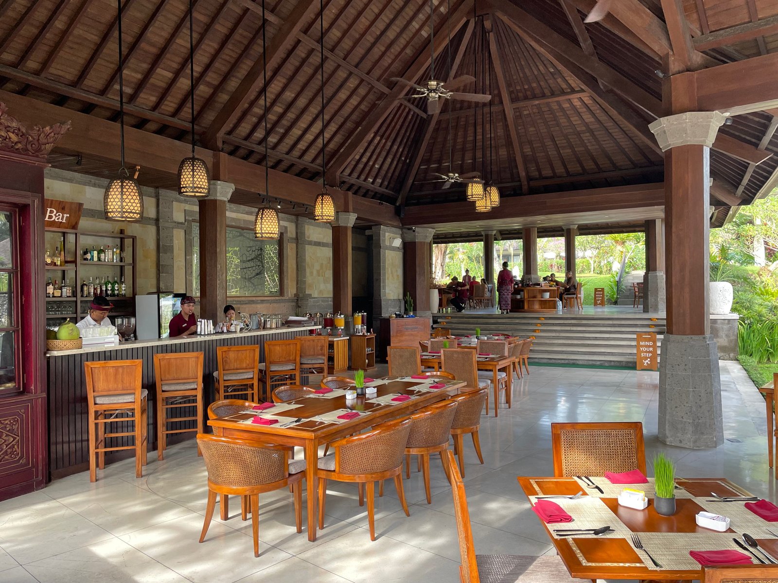 The open-sided pavilion of Lesung restaurant at Visesa Ubud, with the bar to one side under a high timber roof