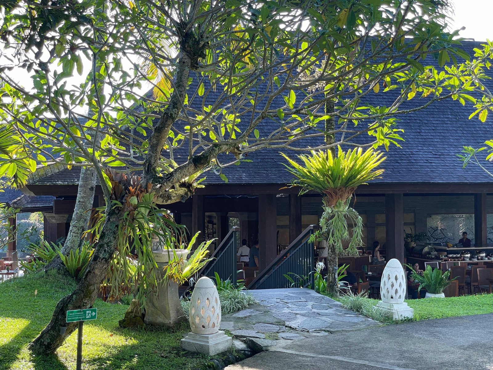 Lesung restaurant at Visesa Ubud seen from the garden, under a frangipani tree