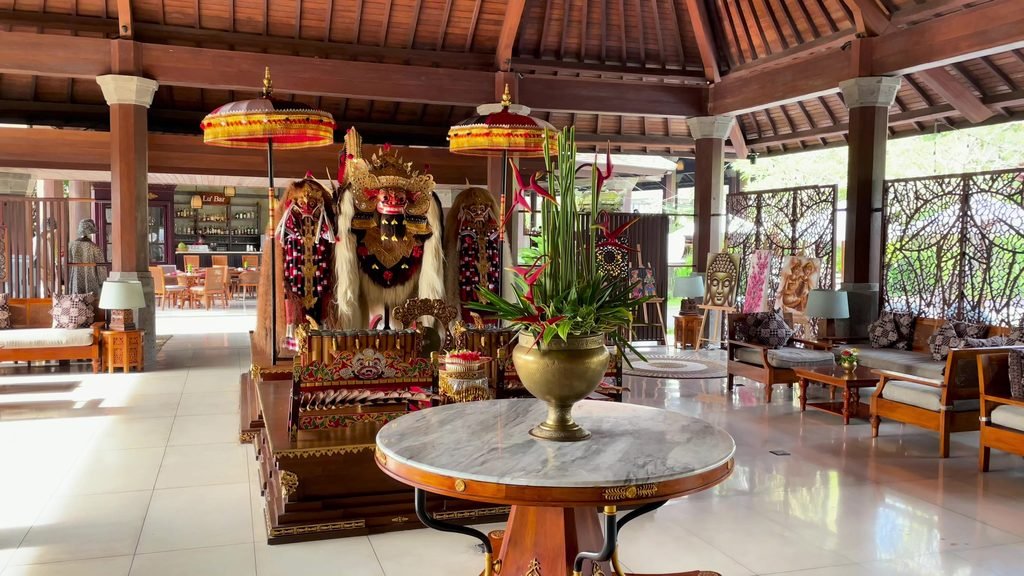 A Barong figure on a carved stand in the lobby of Visesa Ubud