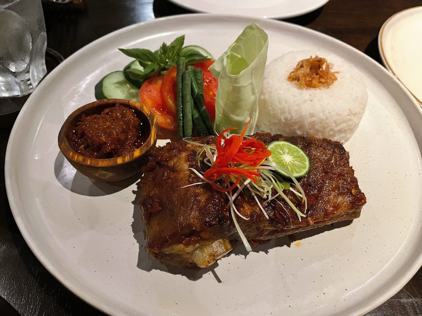 Grilled beef ribs with sambal, rice and fresh vegetables at Lumbung restaurant, Visesa Ubud