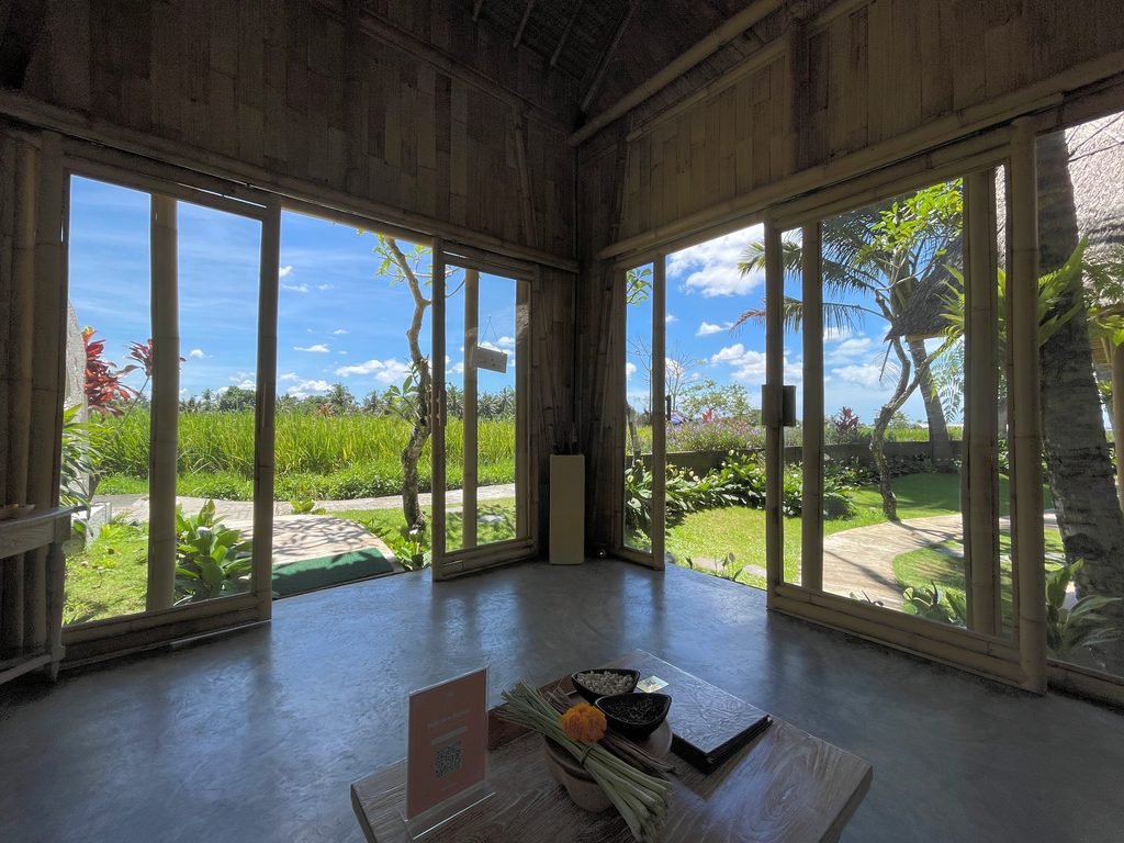 Floor-to-ceiling glass walls at Visesa Spa, Visesa Ubud, looking onto the gardens and rice fields