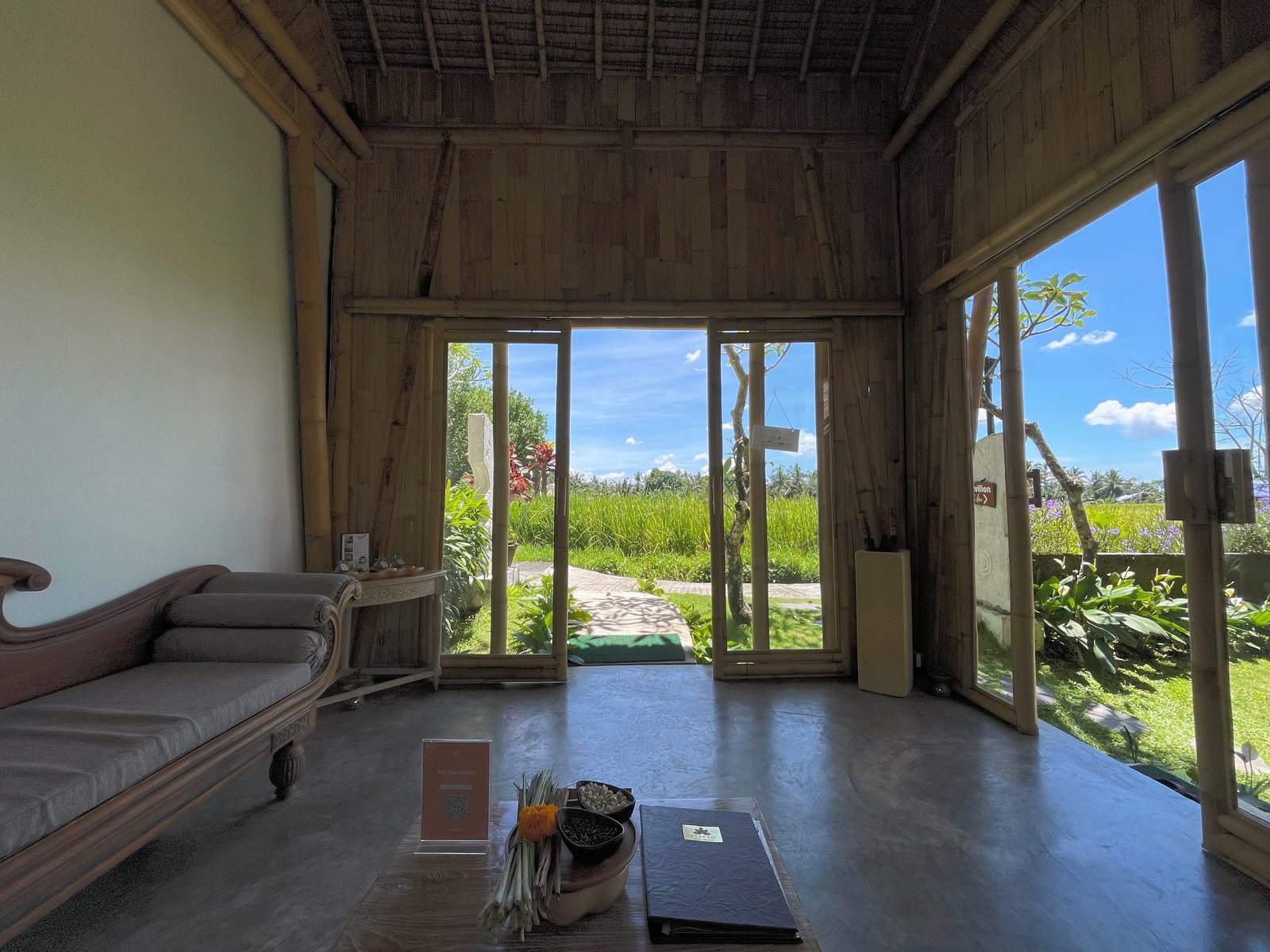 The Visesa Spa reception at Visesa Ubud, its glass doors open to the rice fields