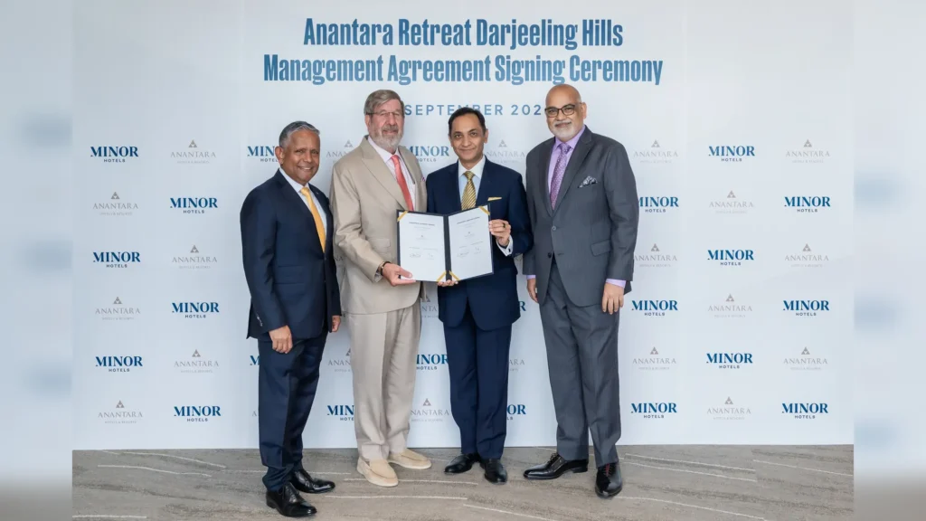 Four executives holding the signed Anantara Retreat Darjeeling Hills management agreement