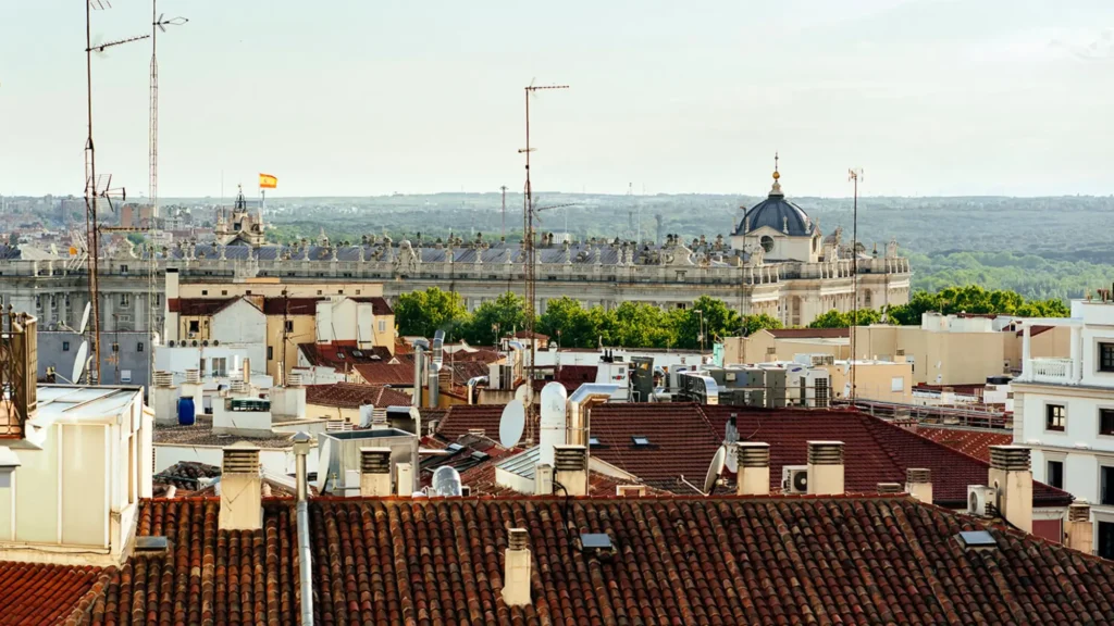 View across terracotta rooftops of central Madrid towards the Royal Palace