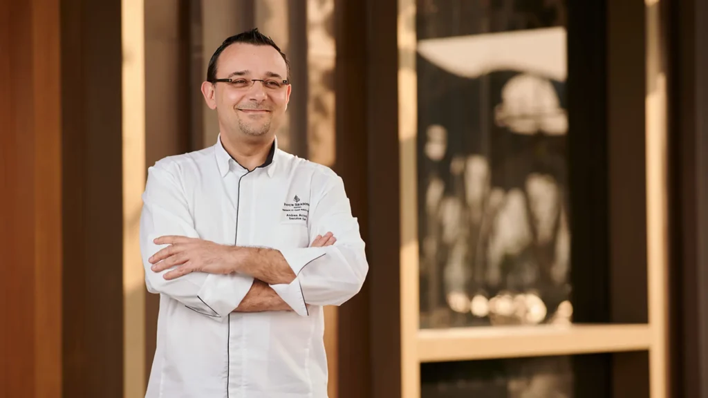 Chef Andrea Accordi in white chef jacket, arms folded