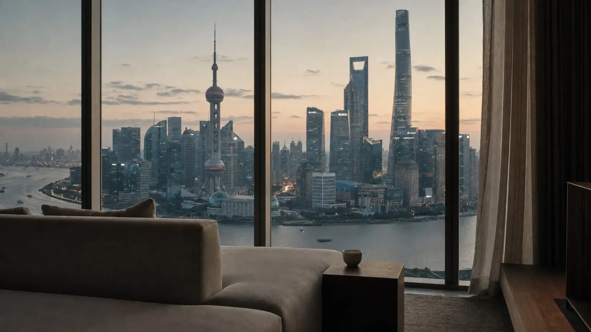 Illustration of a hotel suite looking out on the Lujiazui skyline and the Oriental Pearl Tower in Shanghai at dusk
