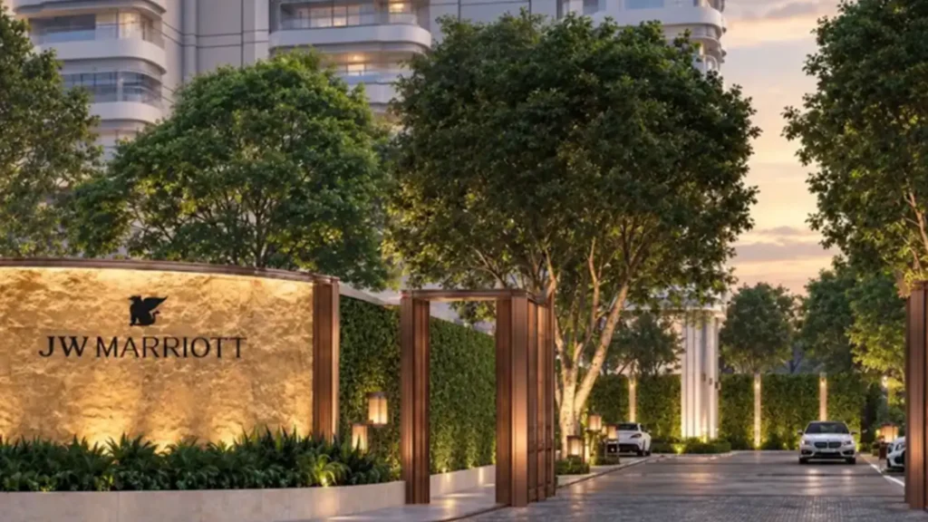 Rendering of the JW Marriott Bangkok Sathorn entrance sign and tree-lined arrival drive at dusk