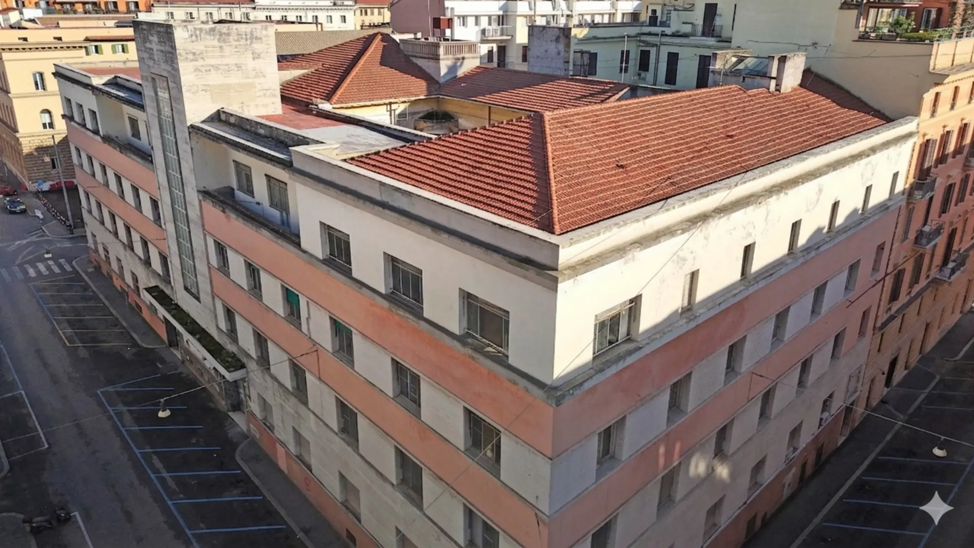 Aerial view of a corner building with a terracotta tiled roof in central Rome, the future Kimpton hotel