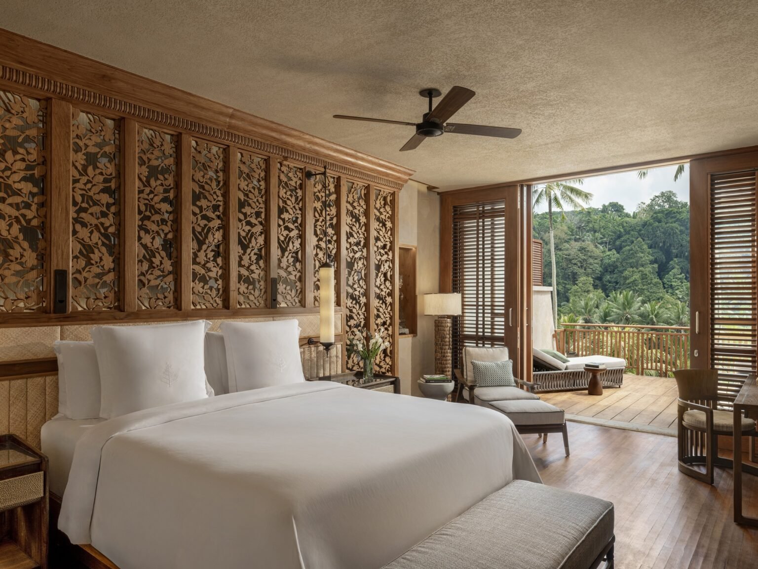 A riverside suite at Four Seasons Bali at Sayan with carved Balinese panels and a jungle-view deck
