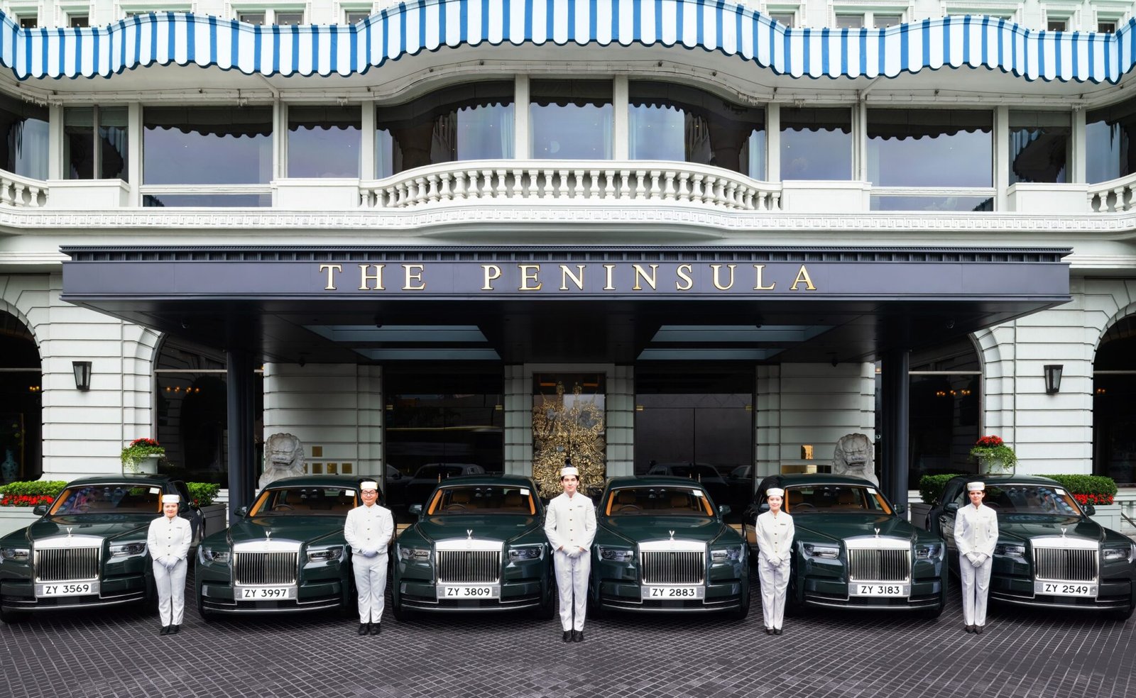 Peninsula-green Rolls-Royce Phantoms and pageboys at the entrance of The Peninsula Hong Kong