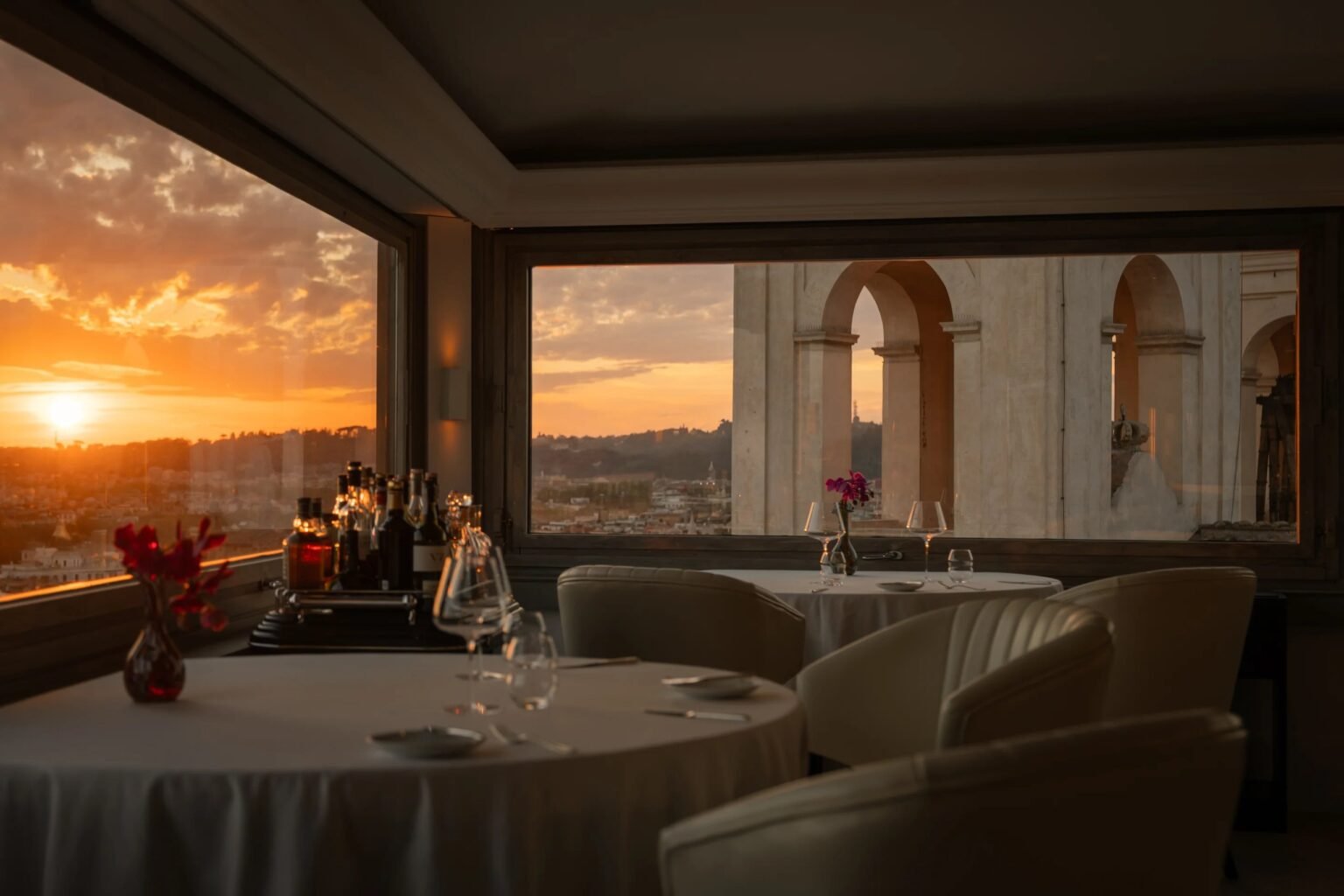 Imàgo restaurant at Hassler Roma at sunset, with windows over the Rome skyline