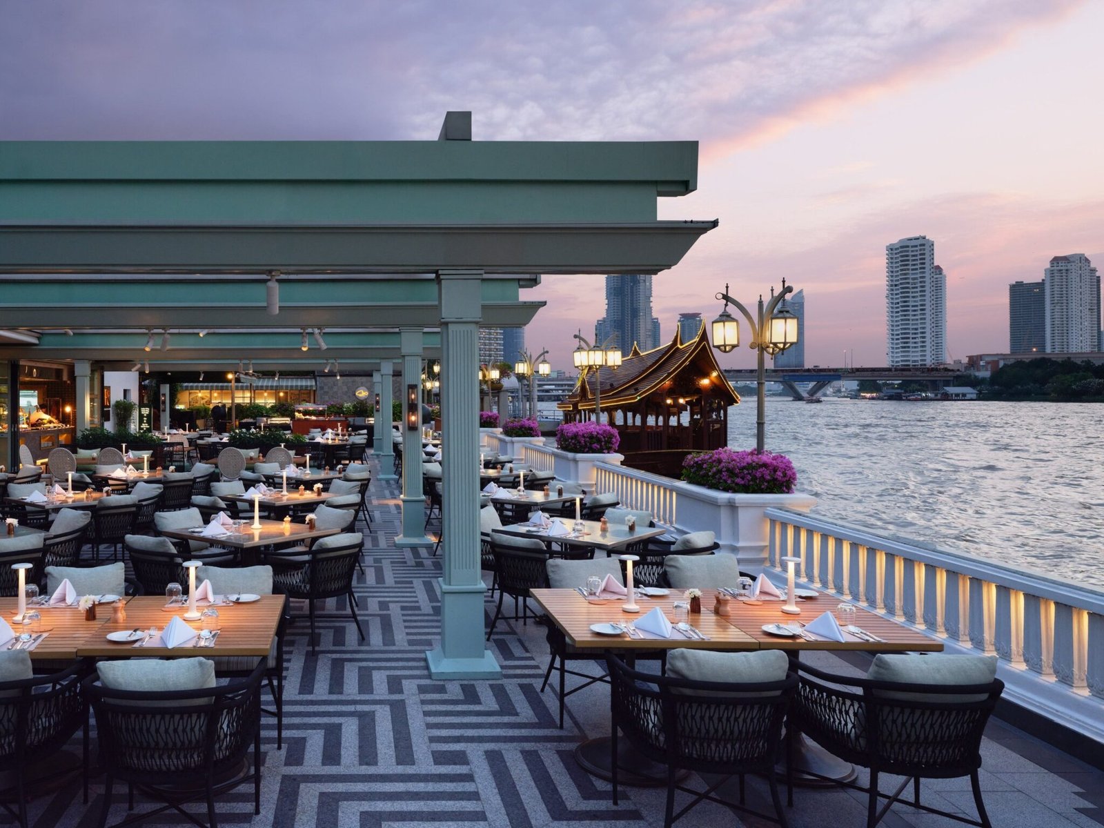 Riverside Terrace at Mandarin Oriental, Bangkok at dusk on the Chao Phraya River
