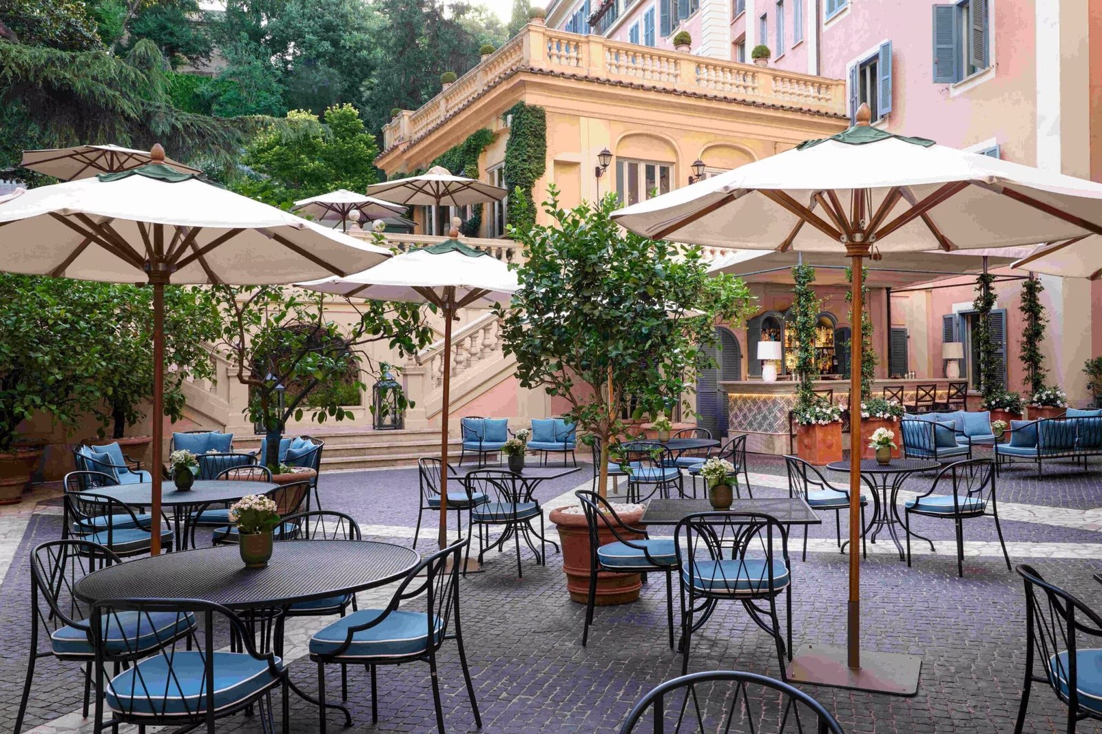 Stravinskij Bar courtyard at Hotel de Russie, Rome, with parasols and lemon trees
