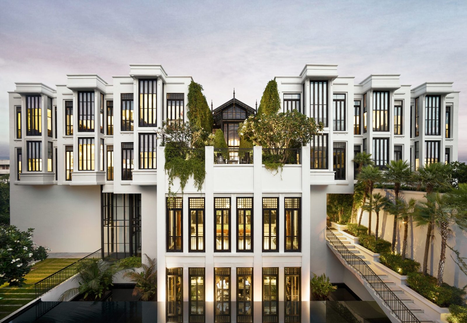 The white Main Residence of The Siam, Bangkok, at dusk above its reflecting pool